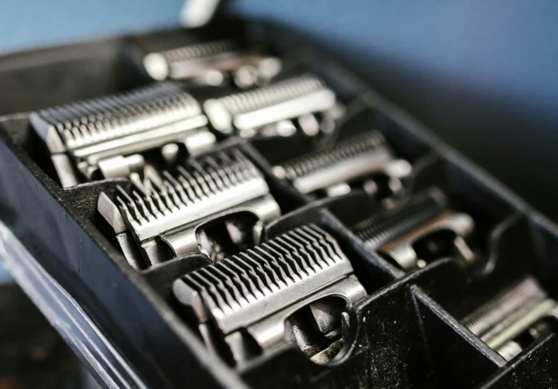 Close-up view of professional barber trimmer attachments neatly arranged in a black box.