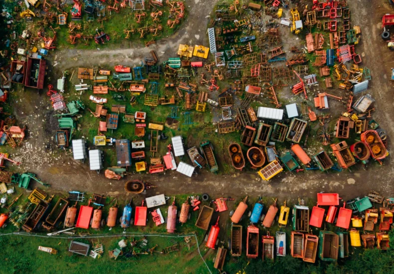 Vibrant aerial shot of a scrapyard filled with colorful metal items in Northern Ireland.