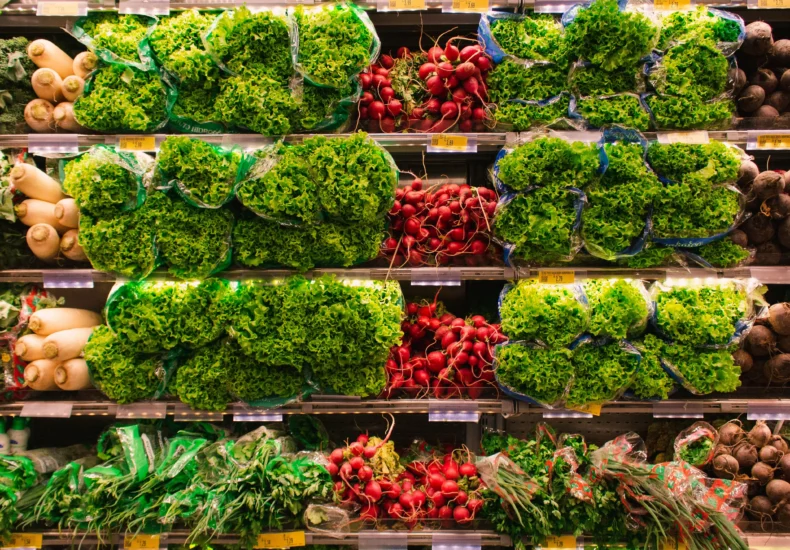 Colorful assortment of fresh vegetables arranged on supermarket shelves, perfect for healthy eating themes.