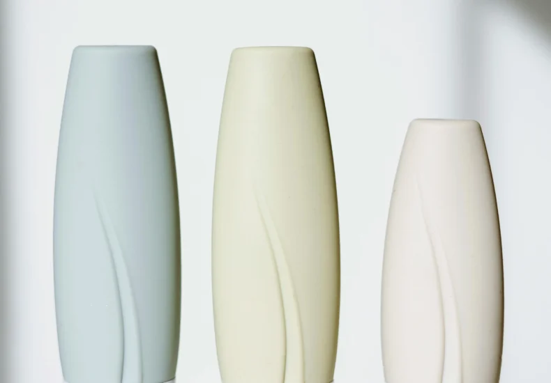 Elegant tubes of skincare products in a minimalist setup with bright lighting.